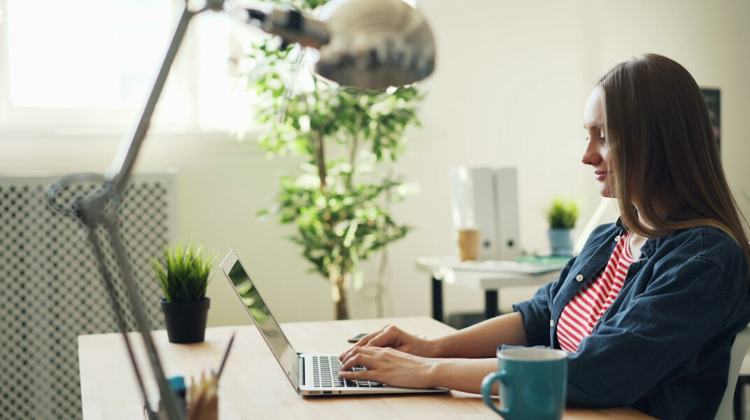 woman coding on laptop in office