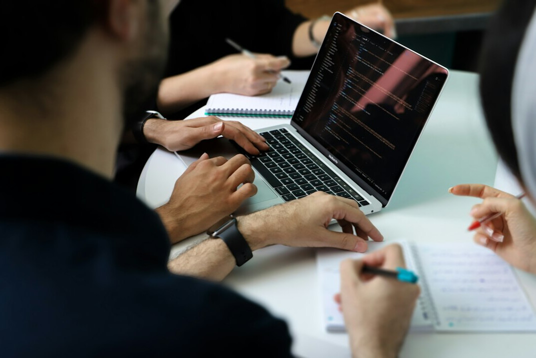 person coding at desk